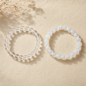 Clear quartz and white selenite natural gemstone bracelets arranged for comparison