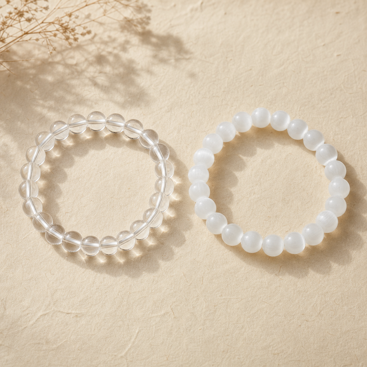 Clear quartz and white selenite natural gemstone bracelets arranged for comparison
